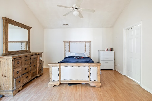 bedroom featuring light hardwood / wood-style floors, lofted ceiling, and ceiling fan