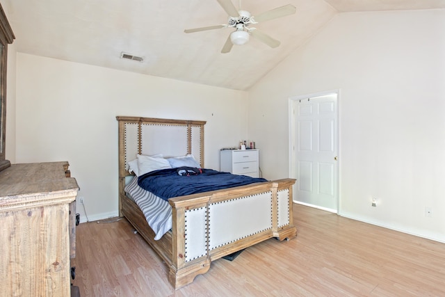 bedroom featuring light hardwood / wood-style floors, lofted ceiling, and ceiling fan