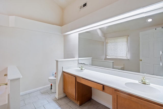 bathroom with vanity, tile patterned floors, and toilet