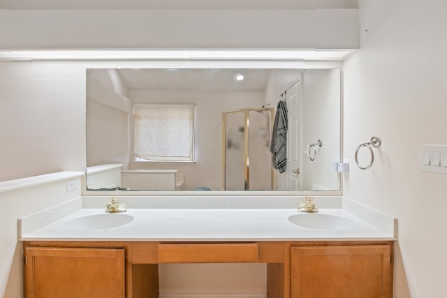 bathroom featuring vanity and an enclosed shower