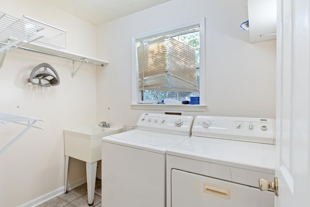 laundry area featuring washing machine and clothes dryer and light tile patterned floors