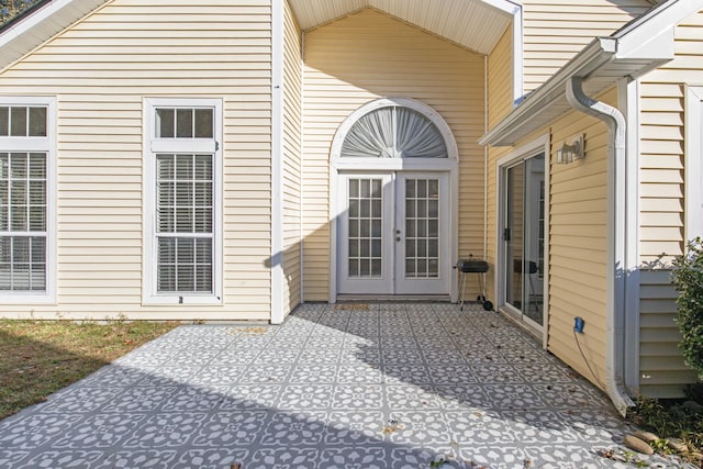 view of exterior entry featuring a patio area