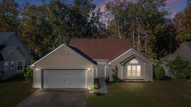 ranch-style home with a lawn and a garage