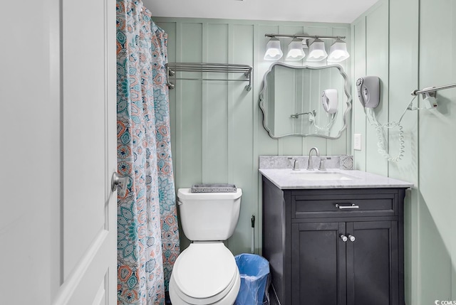 bathroom featuring vanity, toilet, and a shower with curtain