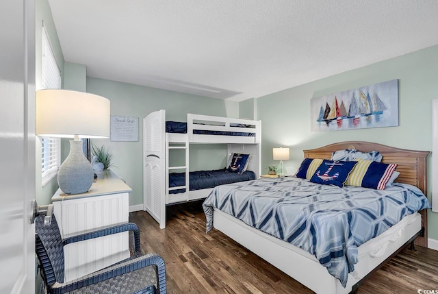 bedroom featuring dark wood-type flooring and a textured ceiling