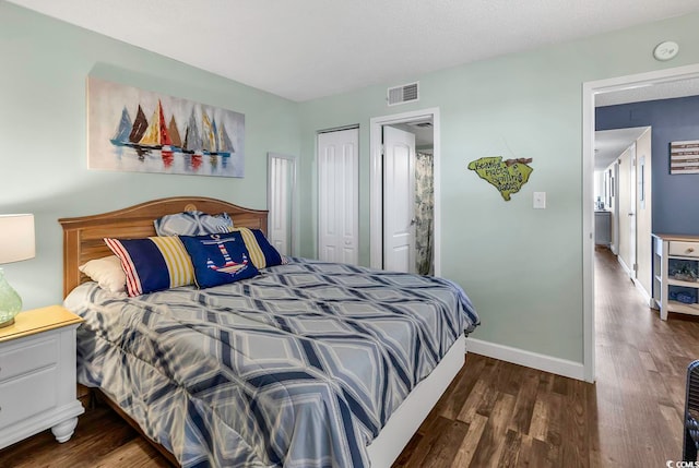 bedroom featuring a textured ceiling, a closet, and dark hardwood / wood-style flooring