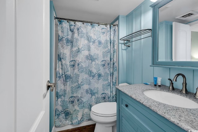 bathroom featuring vanity, a shower with curtain, hardwood / wood-style flooring, and toilet