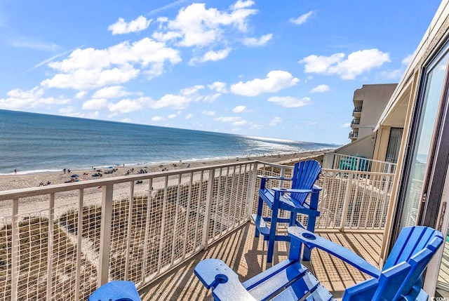 balcony featuring a water view and a view of the beach