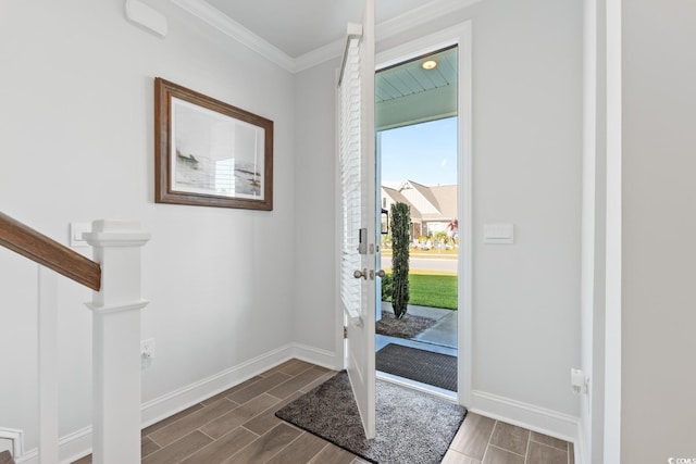 entrance foyer with ornamental molding and dark wood-type flooring