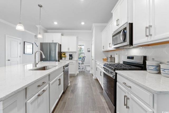 kitchen with appliances with stainless steel finishes, sink, and white cabinets