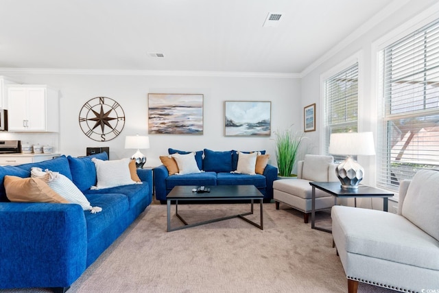 living room featuring light carpet, crown molding, and plenty of natural light