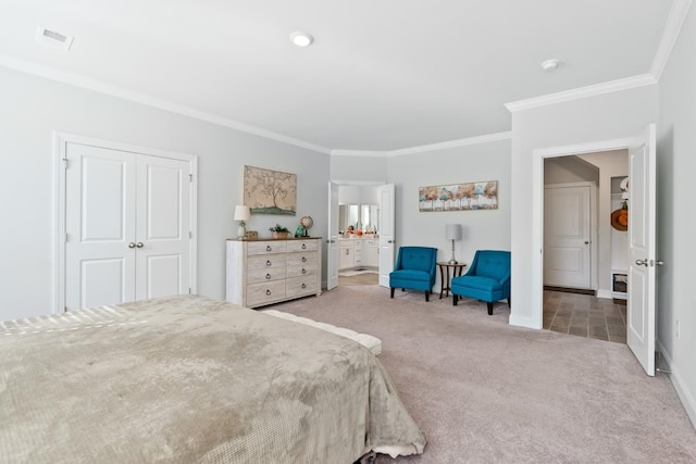 bedroom with crown molding, carpet floors, and a closet