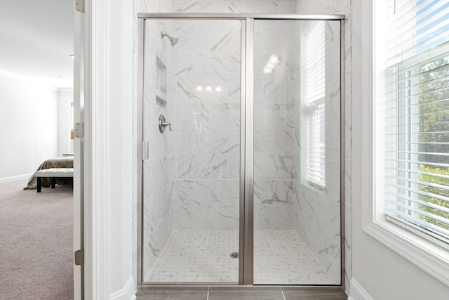 bathroom with a shower with shower door