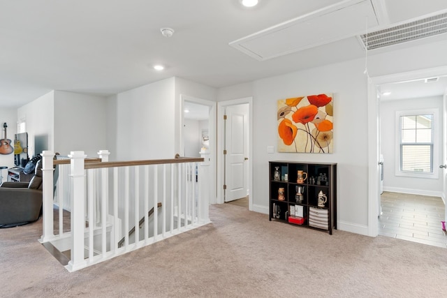 hall featuring light colored carpet