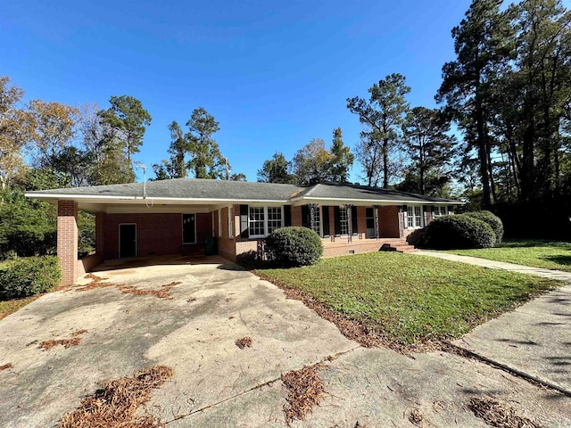 ranch-style house with a front lawn, covered porch, and a carport