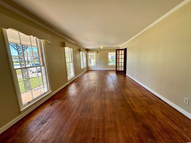 spare room featuring crown molding and dark hardwood / wood-style flooring