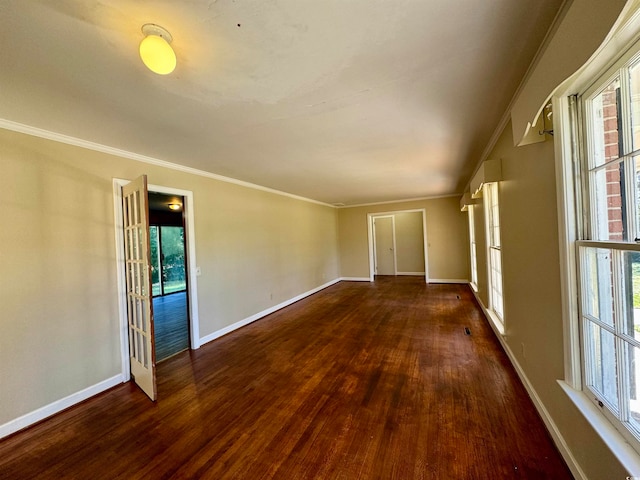 unfurnished room featuring crown molding, dark hardwood / wood-style floors, and french doors