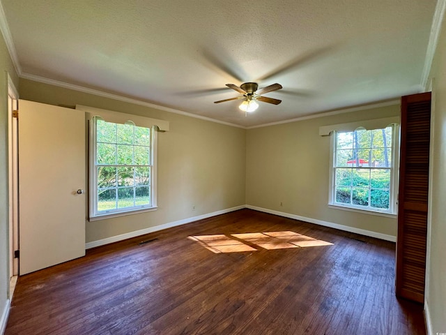 spare room with ceiling fan, dark hardwood / wood-style flooring, crown molding, and a textured ceiling