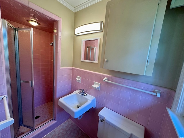 bathroom featuring toilet, a shower with door, ornamental molding, and sink