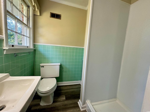 bathroom with sink, hardwood / wood-style floors, toilet, walk in shower, and crown molding