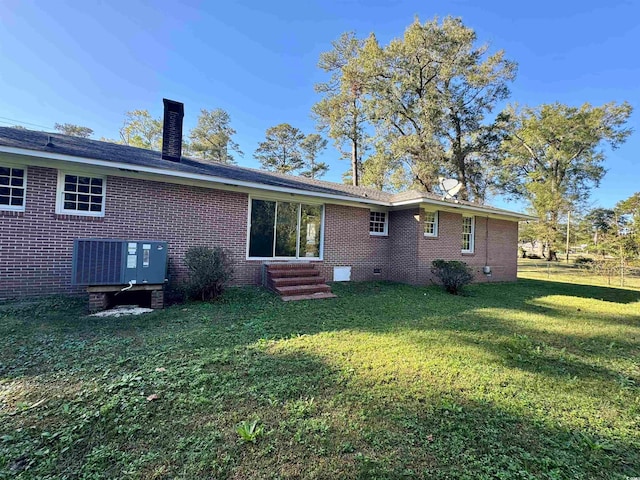 back of house with a lawn