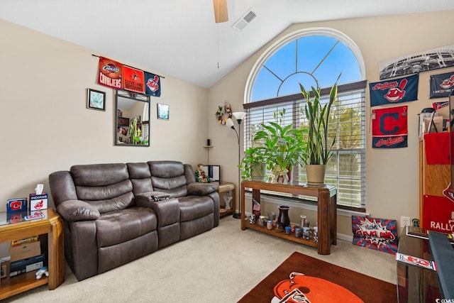 living room featuring lofted ceiling, carpet floors, and ceiling fan