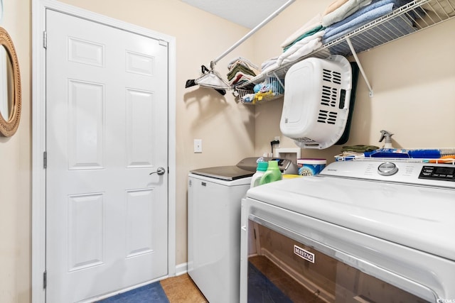 washroom with washer and dryer