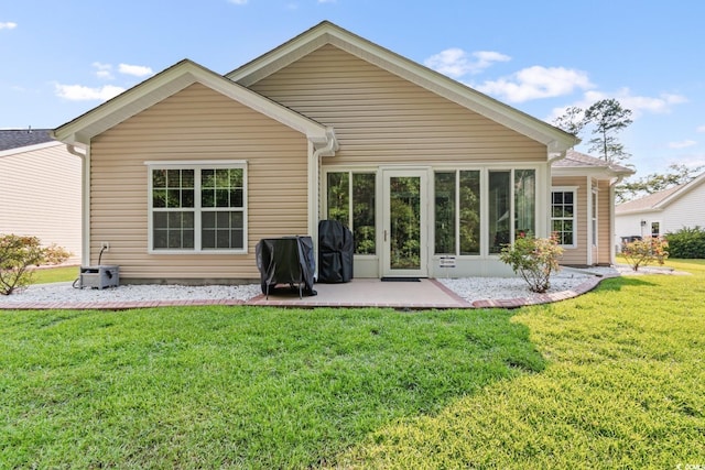 back of property featuring a patio area and a yard