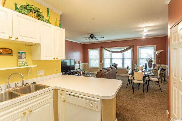 kitchen with white dishwasher, dark colored carpet, sink, ornamental molding, and kitchen peninsula