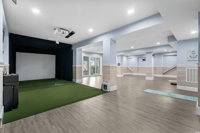 recreation room with wood-type flooring and golf simulator