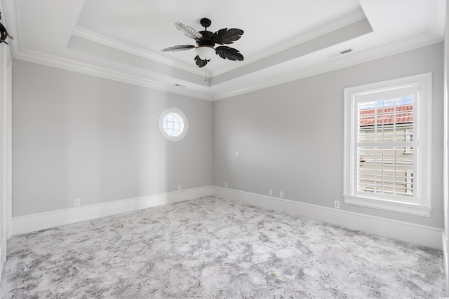 unfurnished room featuring a tray ceiling, ceiling fan, and ornamental molding