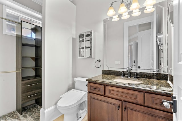 bathroom featuring vanity, toilet, and a chandelier