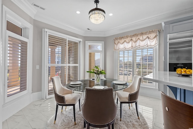 dining room featuring crown molding