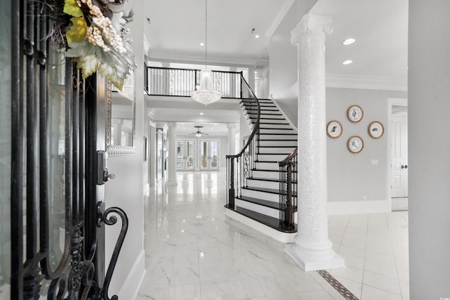 entrance foyer featuring ornate columns, crown molding, and ceiling fan