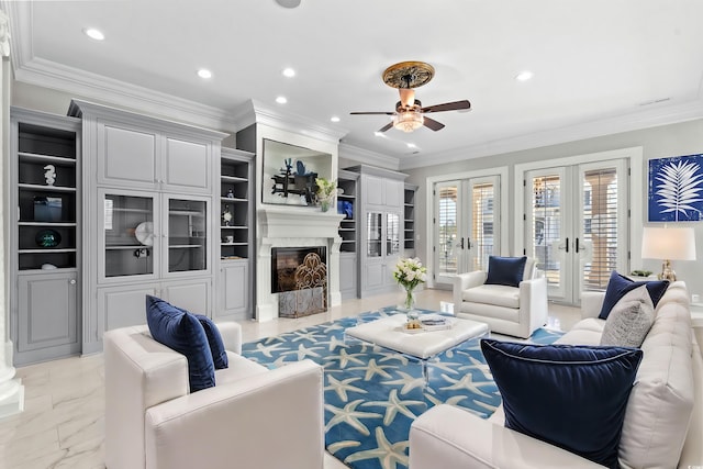 living room featuring a fireplace, french doors, ceiling fan, and built in shelves