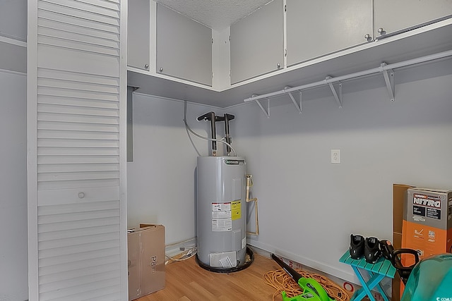 utility room featuring water heater