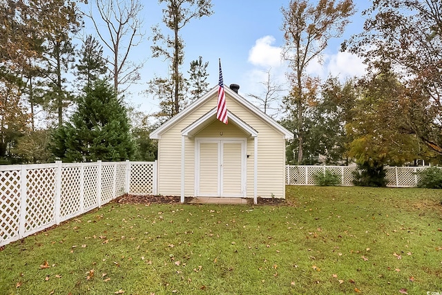 view of outbuilding with a lawn