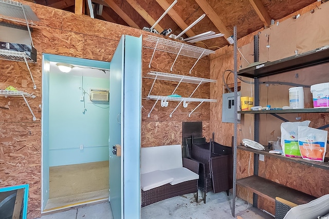 interior space with electric panel and a wall unit AC