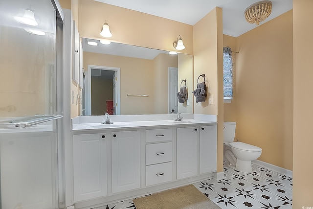 bathroom featuring tile patterned flooring, vanity, and toilet