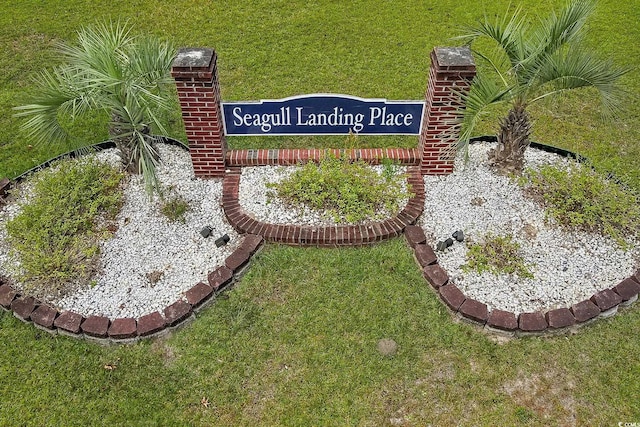 community sign featuring a lawn