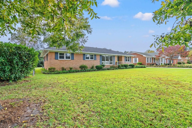 ranch-style home featuring a front yard