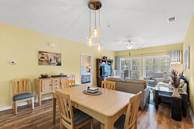 dining area featuring dark wood-type flooring and ceiling fan