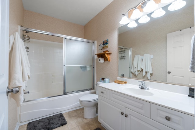 full bathroom with vanity, combined bath / shower with glass door, and toilet