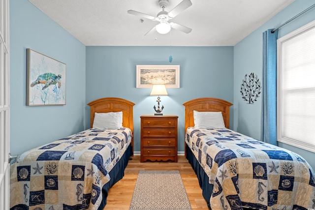 bedroom with wood-type flooring and ceiling fan