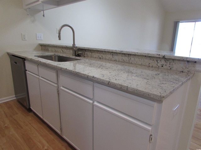 kitchen featuring white cabinetry, light hardwood / wood-style floors, sink, and stainless steel dishwasher