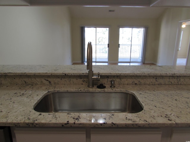 kitchen with light stone countertops and sink