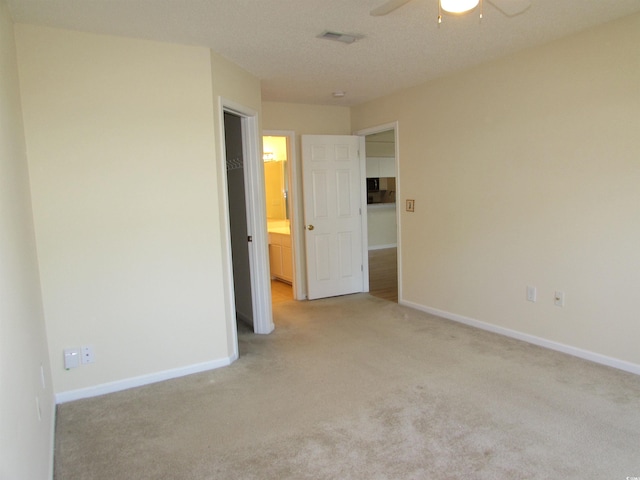 empty room with ceiling fan and light colored carpet