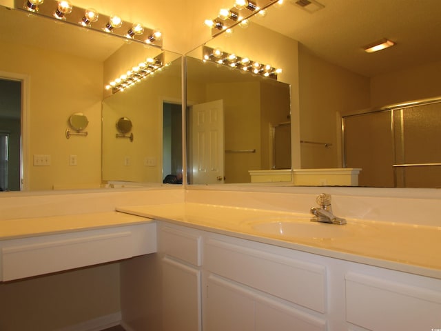 bathroom featuring vanity and an enclosed shower