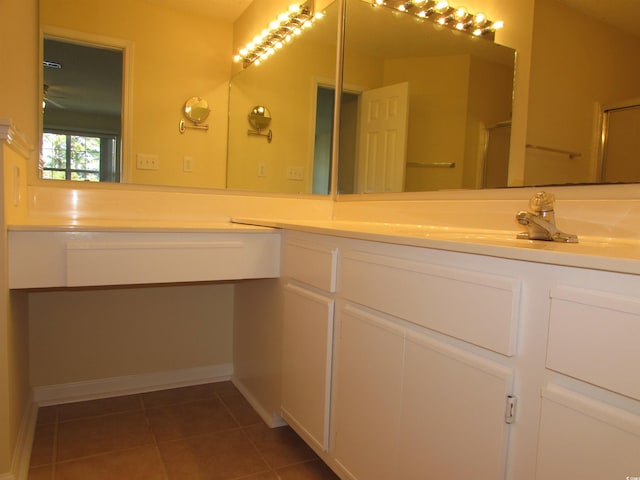 bathroom with vanity, tile patterned flooring, and walk in shower