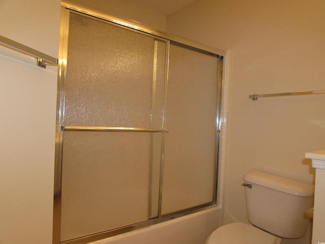 bathroom with toilet and enclosed tub / shower combo